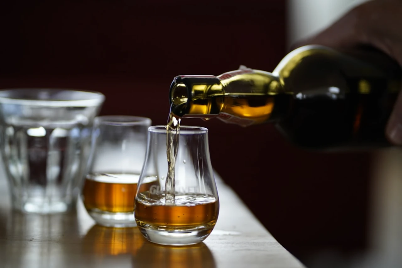 Whiskey being poured into tasting glasses