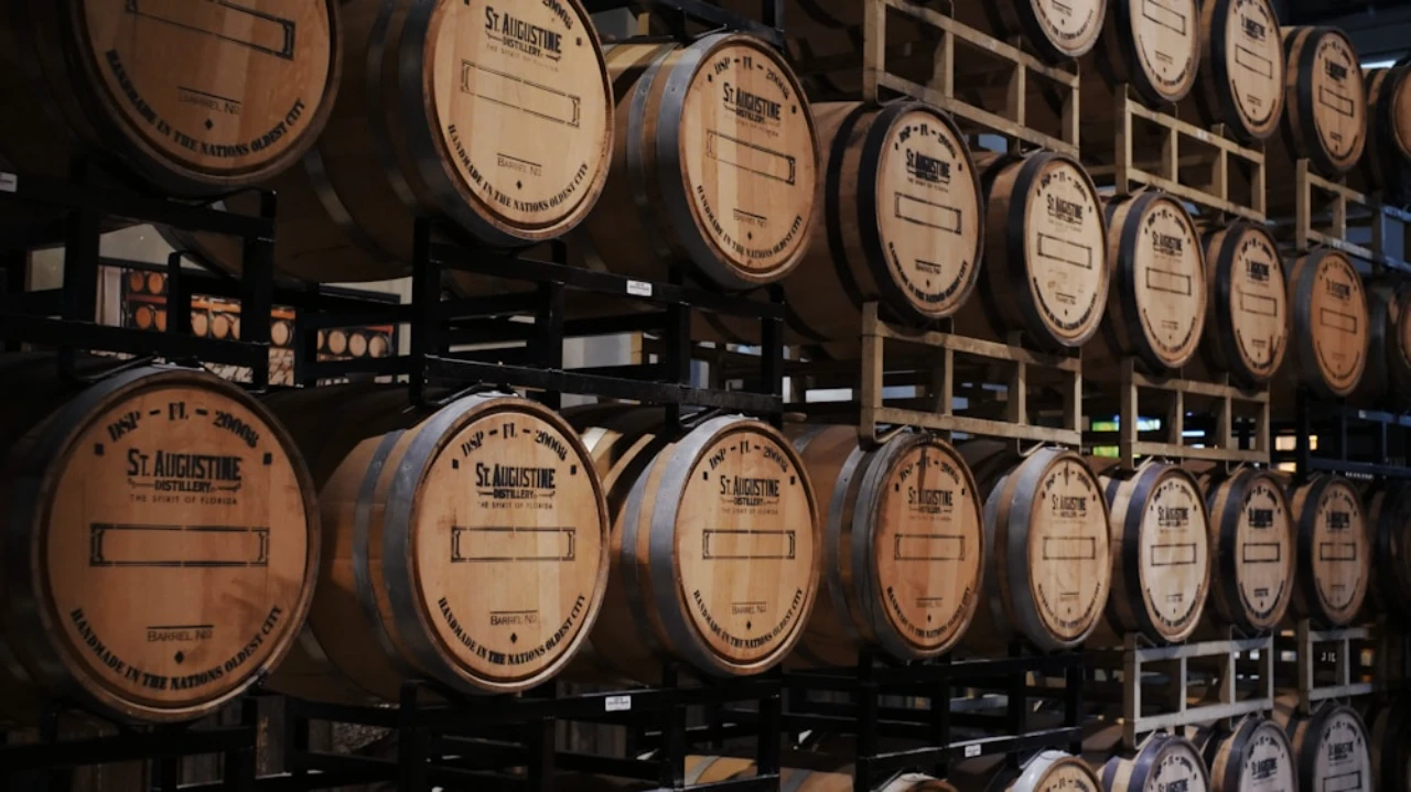 Stacked wooden barrels in distillery warehouse