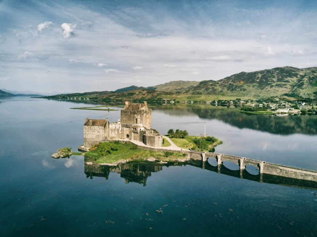Castle on island connected by stone bridge